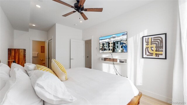 930 Blue River Pkwy Unit 622, Silverthorne, CO 80498 - bedroom with light wood finished floors, recessed lighting, baseboards, ensuite bathroom, and a ceiling fan