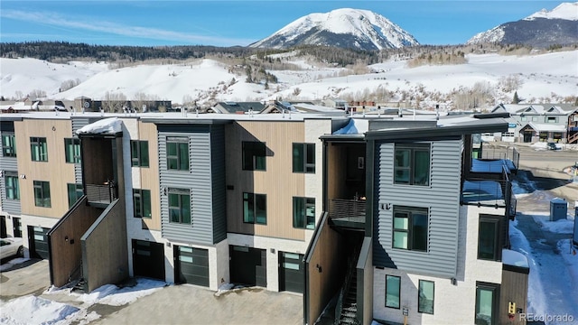 930 Blue River Pkwy Unit 622, Silverthorne, CO 80498 - exterior space with an attached garage, a mountain view, and driveway