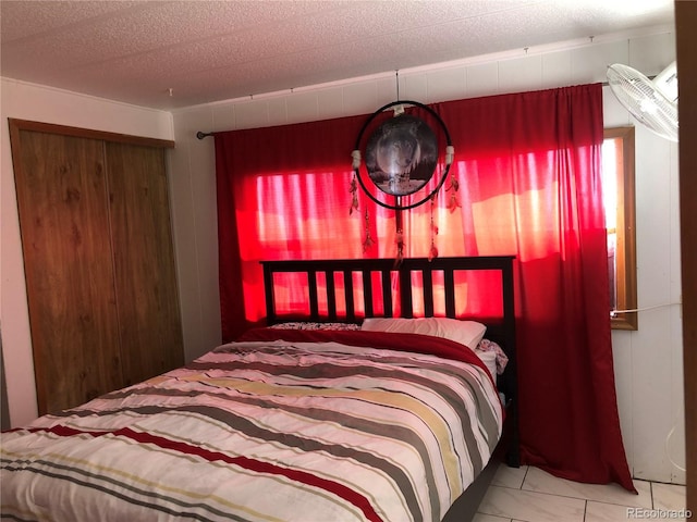 9260 County Road 133, Simla, CO 80835 - bedroom with wooden walls, marble look tiles, and a textured ceiling