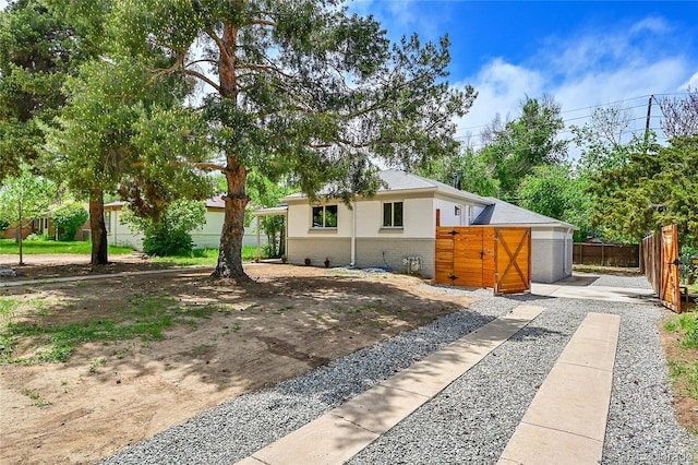 view of front of house featuring fence and brick siding