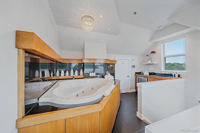 kitchen featuring lofted ceiling, sink, a chandelier, and dark tile patterned floors