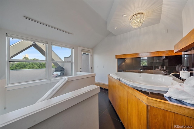 bathroom with lofted ceiling, a bath, tile patterned flooring, and a chandelier