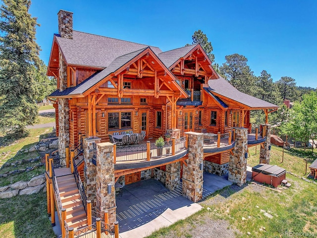 rear view of property featuring an outdoor hangout area and a patio area