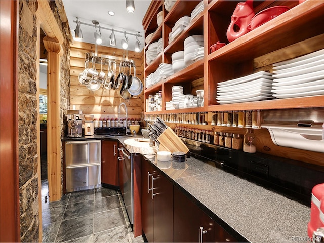 bar featuring rustic walls and sink