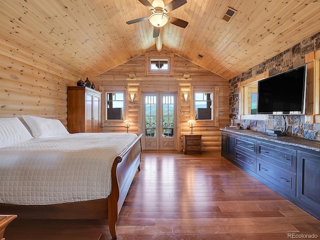 bedroom with high vaulted ceiling, rustic walls, hardwood / wood-style floors, and wooden ceiling