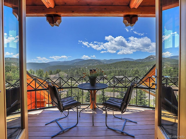 wooden deck with a mountain view