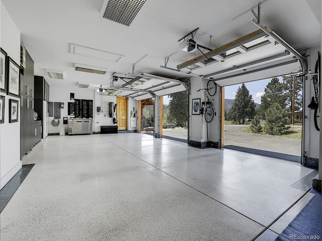 garage with a garage door opener and secured water heater