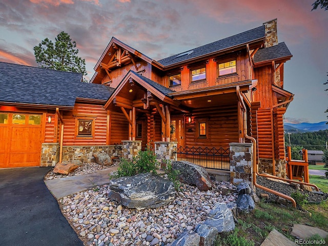 log cabin featuring a garage