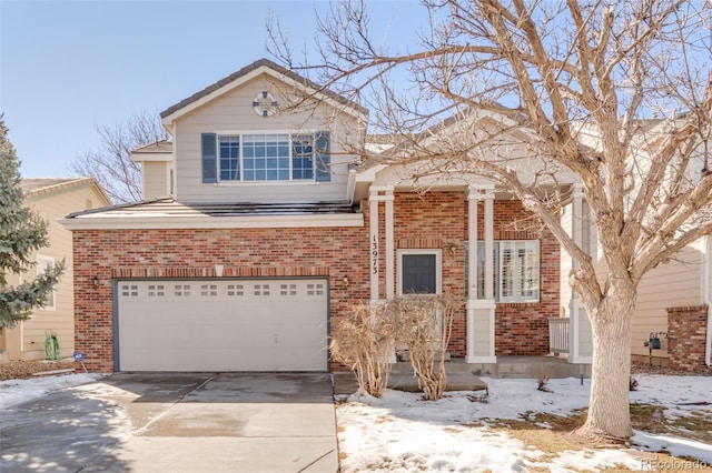 view of front of house featuring concrete driveway, brick siding, and an attached garage