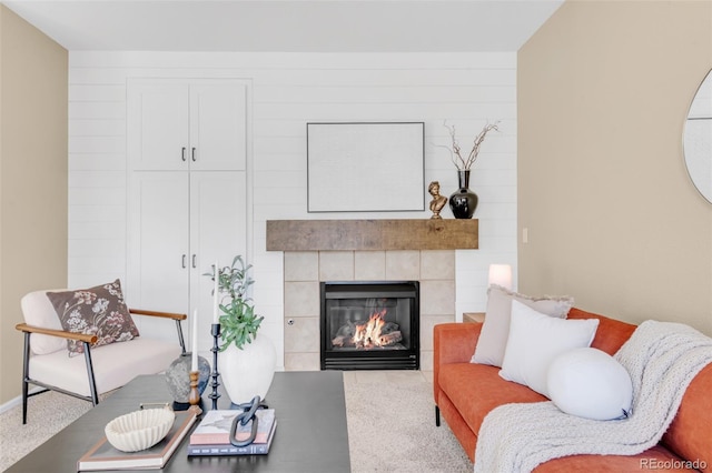 carpeted living room featuring a fireplace