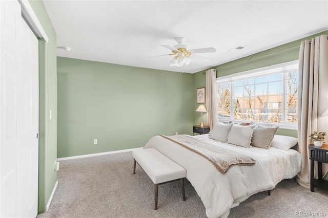 carpeted bedroom featuring ceiling fan, visible vents, and baseboards