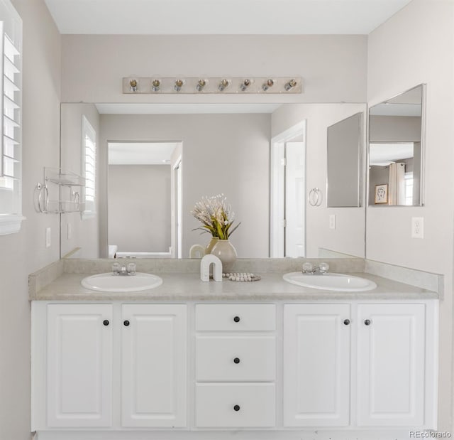 full bath with double vanity and a sink