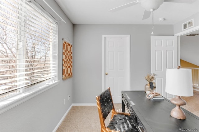 carpeted home office with visible vents, baseboards, and ceiling fan