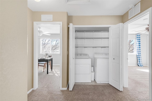 laundry area featuring laundry area, separate washer and dryer, carpet flooring, a ceiling fan, and baseboards