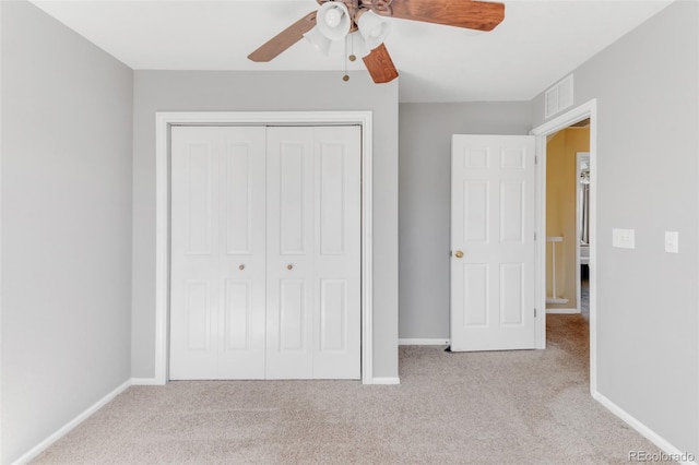 unfurnished bedroom with baseboards, visible vents, a ceiling fan, carpet flooring, and a closet