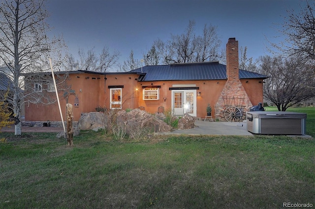 rear view of property featuring a yard