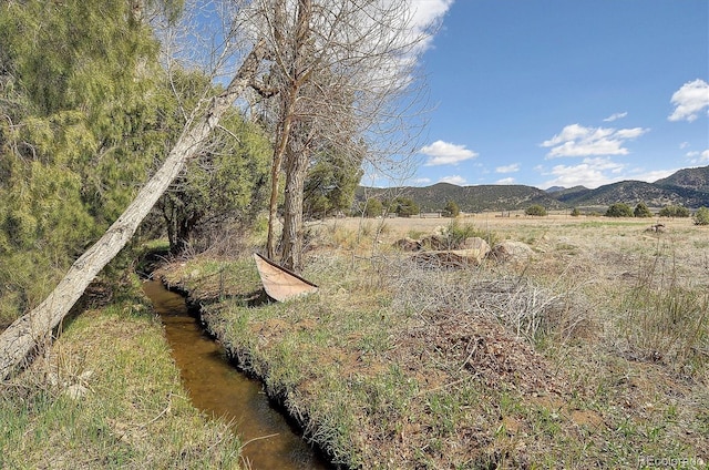 exterior space featuring a water and mountain view