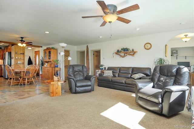 carpeted living room featuring ceiling fan