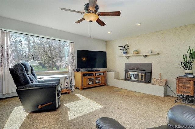 carpeted living room featuring ceiling fan