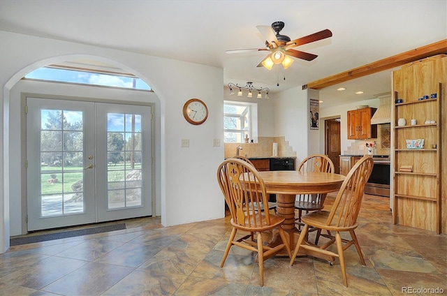 dining room with french doors, ceiling fan, rail lighting, sink, and tile floors