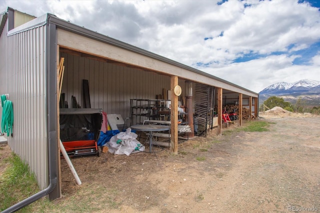 view of horse barn featuring a mountain view and an outdoor structure