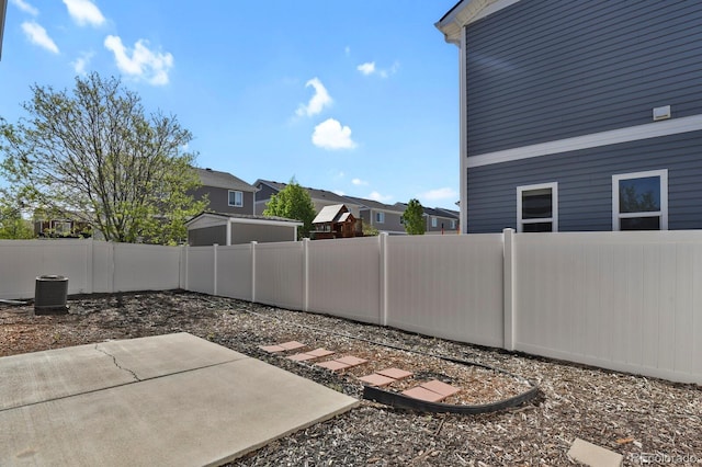 20826 Robins Dr, Denver, CO 80249 - fenced backyard with central air condition unit, a patio, and a residential view