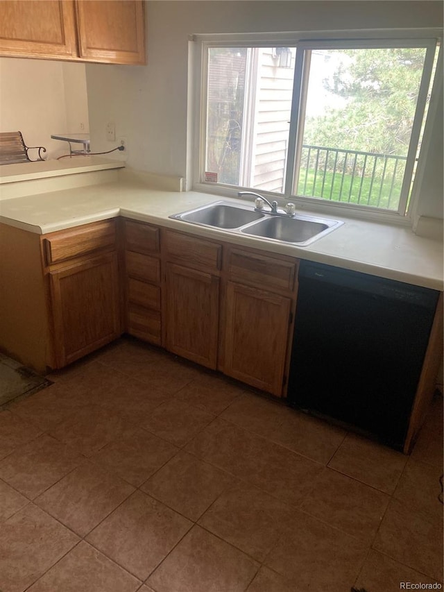 482 S Kalispell Way Unit E, Aurora, CO 80017 - kitchen with black dishwasher, light countertops, and light tile patterned flooring