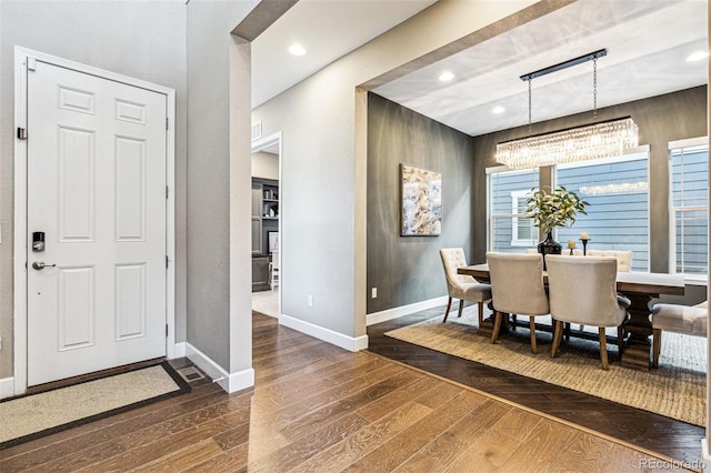 dining area featuring dark wood-style floors, baseboards, a notable chandelier, and recessed lighting