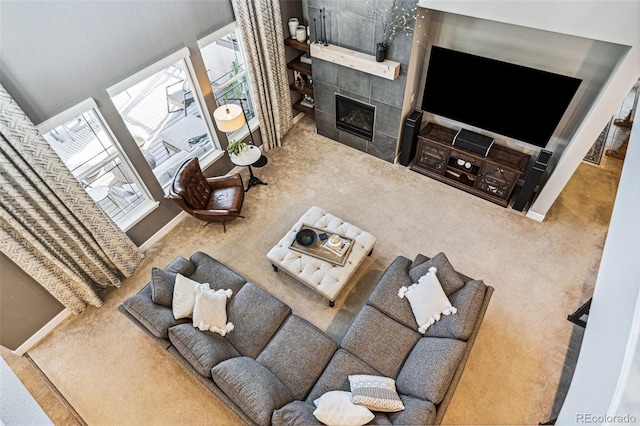 living area with carpet flooring and a tile fireplace