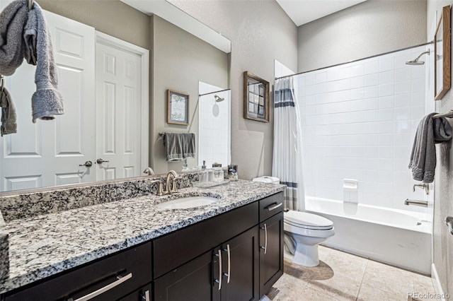 bathroom featuring a textured wall, toilet, vanity, tile patterned floors, and shower / bath combo with shower curtain