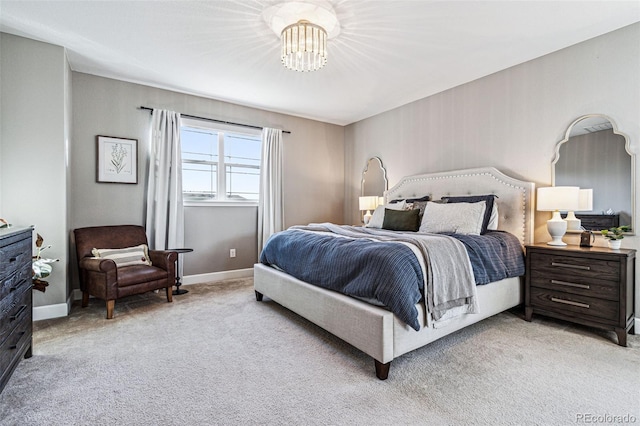 bedroom featuring light carpet, baseboards, and a chandelier