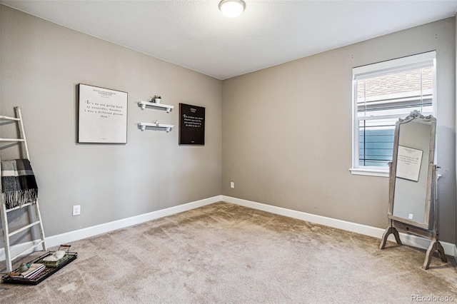 interior space featuring carpet flooring and baseboards