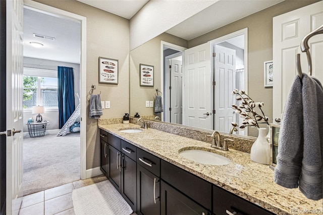 full bathroom featuring tile patterned floors, visible vents, a sink, and double vanity