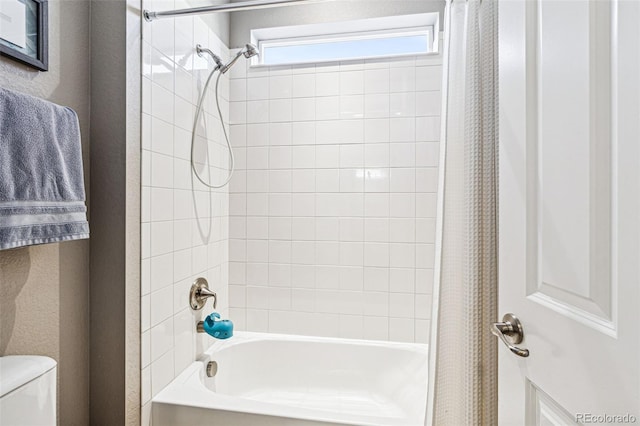 full bath featuring shower / bath combination with curtain, a textured wall, and toilet