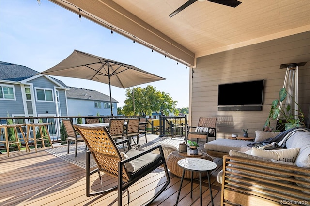 wooden deck featuring ceiling fan and outdoor lounge area