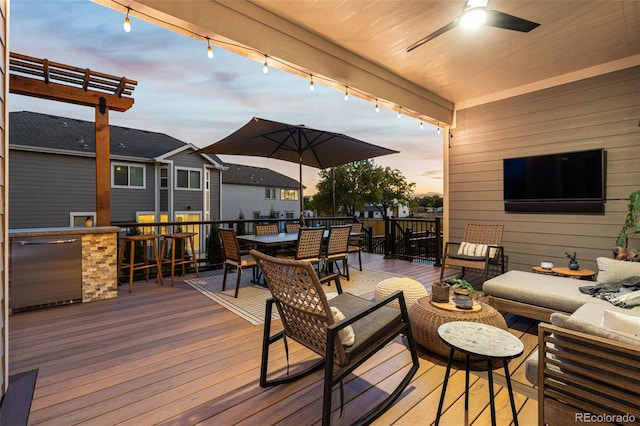 wooden deck featuring ceiling fan, an outdoor hangout area, and outdoor dining area