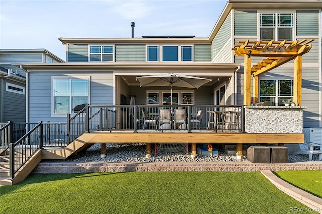 rear view of house featuring stairs, a deck, solar panels, and a yard