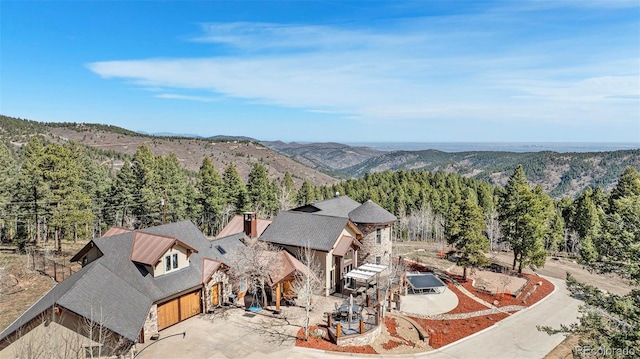 bird's eye view featuring a forest view and a mountain view