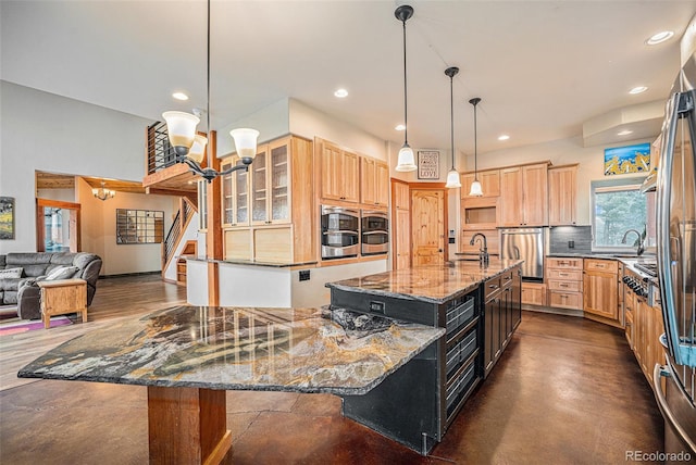 kitchen with light brown cabinetry, a sink, dark stone counters, recessed lighting, and backsplash
