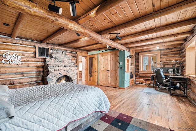 bedroom featuring rustic walls, wood ceiling, and hardwood / wood-style floors
