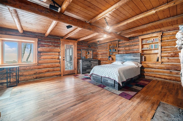 bedroom featuring beamed ceiling, wooden ceiling, log walls, and hardwood / wood-style flooring