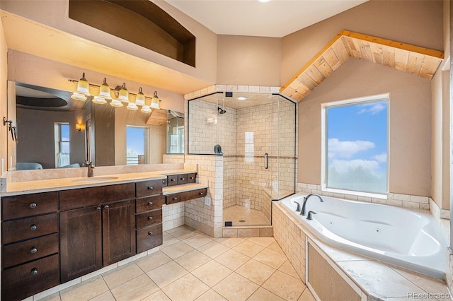 full bath with a tub with jets, vanity, tile patterned flooring, and a shower stall