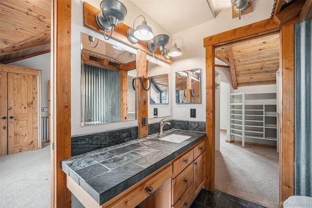 bathroom with wood ceiling, lofted ceiling, and vanity