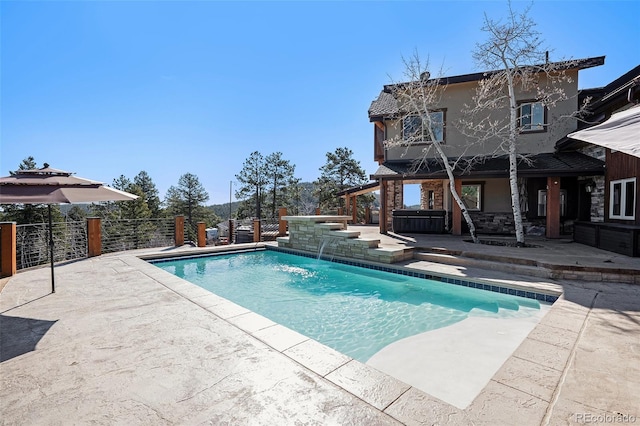 view of swimming pool with a patio, a hot tub, fence private yard, and a fenced in pool
