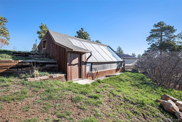 view of property exterior featuring an exterior structure and an outbuilding