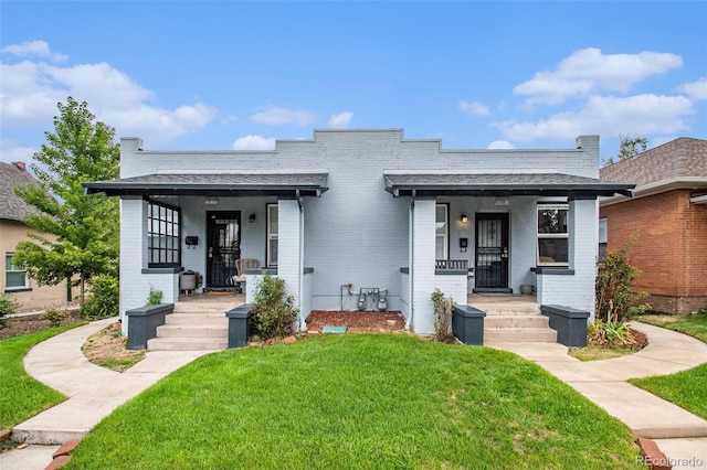 3764 N Raleigh St, Denver, CO 80212 - view of front of home with covered porch, a front lawn, and brick siding
