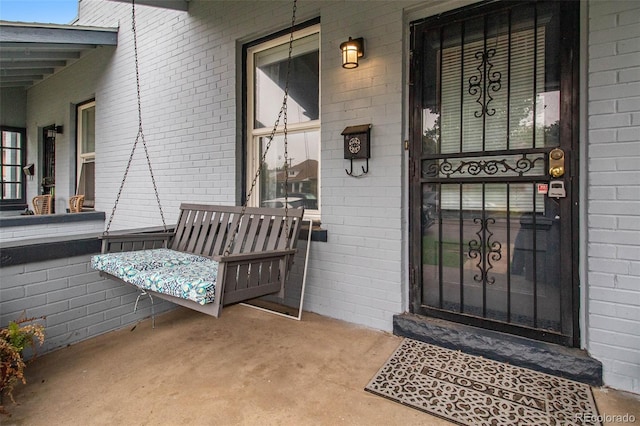 3764 N Raleigh St, Denver, CO 80212 - doorway to property featuring covered porch and brick siding