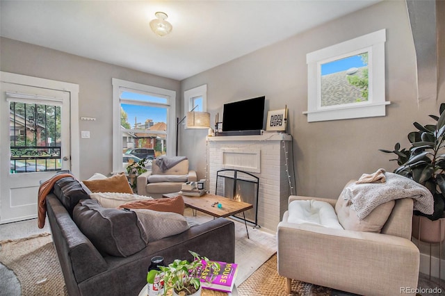 3764 N Raleigh St, Denver, CO 80212 - living area featuring plenty of natural light, a brick fireplace, and baseboards