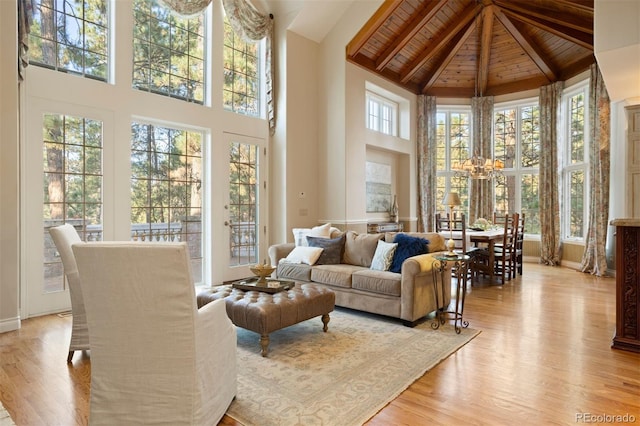 sunroom with wood ceiling, a healthy amount of sunlight, and vaulted ceiling with beams