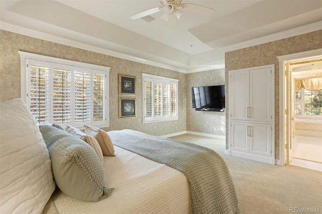 carpeted bedroom featuring ceiling fan, crown molding, multiple windows, and ensuite bath